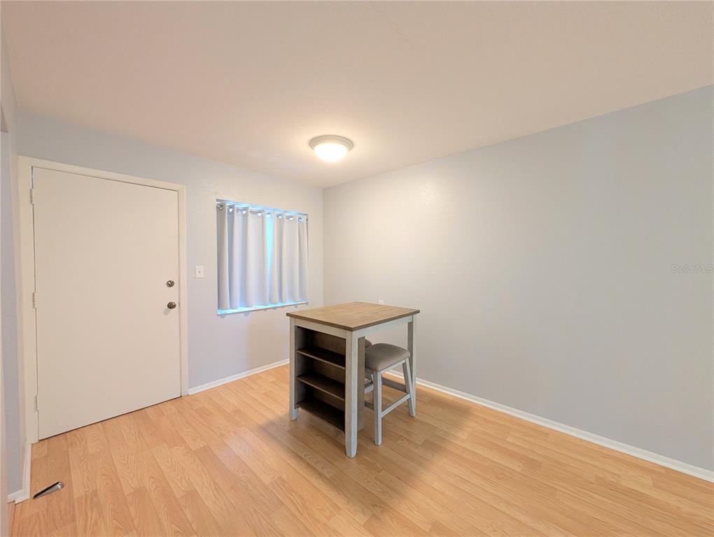 1540 Pleasant Road, Unit G35 Bradenton, FL 34207 - Photo 19 of 23 a view of an empty room with wooden floor and a window