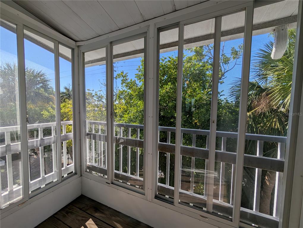 1540 Pleasant Road, Unit G35 Bradenton, FL 34207 - Photo 20 of 23 a view of a balcony with floor to ceiling windows and wooden floor