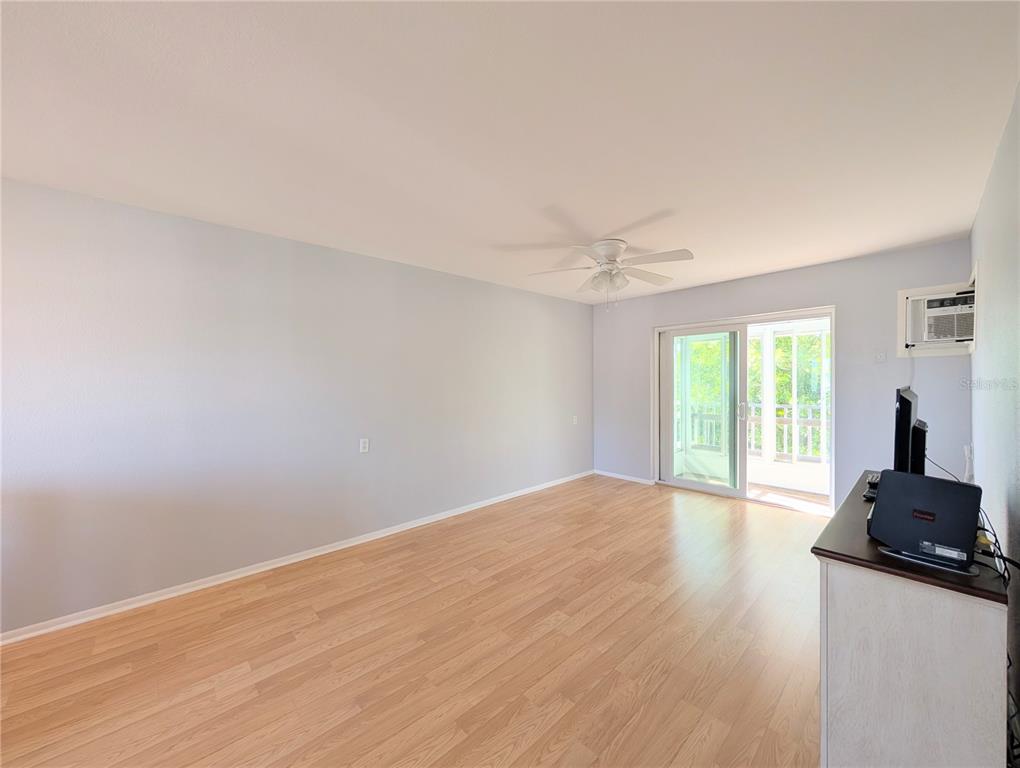 1540 Pleasant Road, Unit G35 Bradenton, FL 34207 - Photo 3 of 23 a view of a room with wooden floor and a window