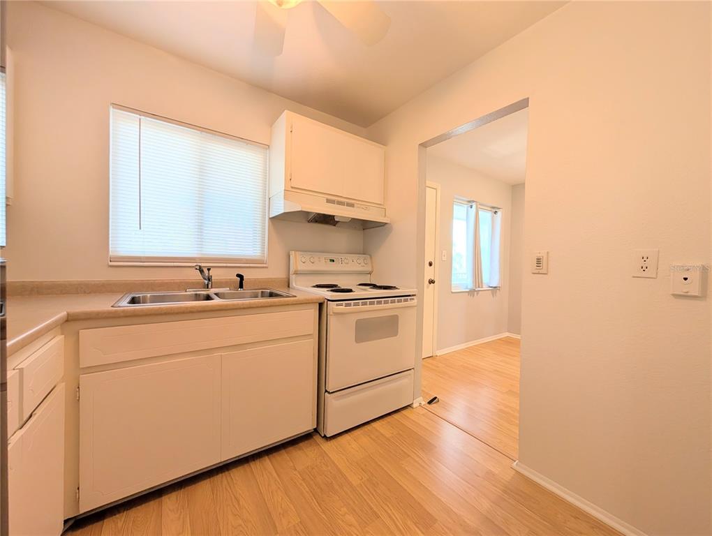 1540 Pleasant Road, Unit G35 Bradenton, FL 34207 - Photo 7 of 23 a kitchen with white cabinets and white appliances
