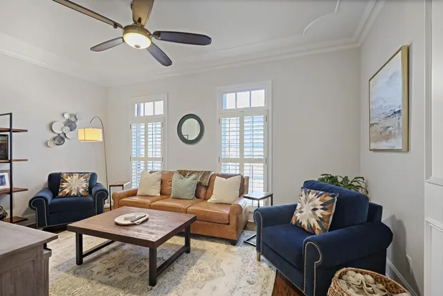 a living room with furniture a rug and a window