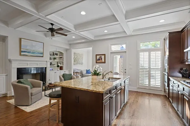 a open kitchen with stainless steel appliances granite countertop a sink and dishwasher a oven with wooden floor