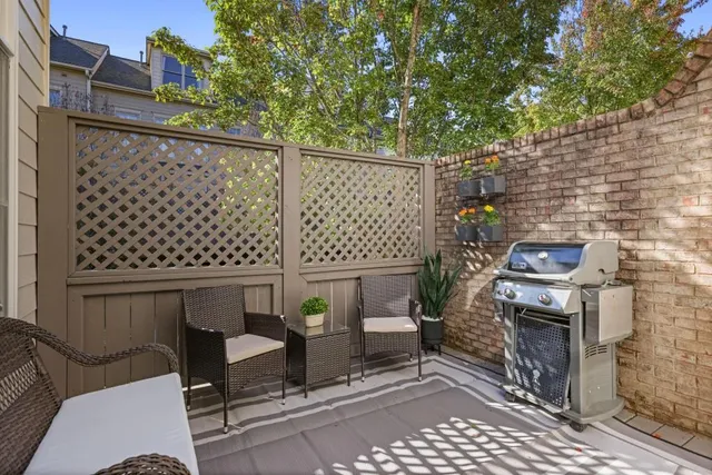 a view of a chairs and table in the balcony