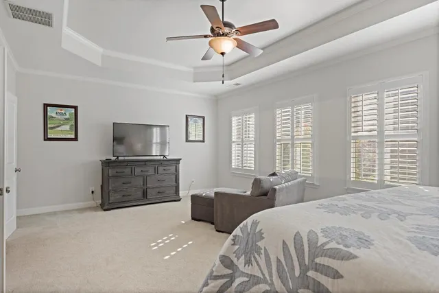 a bedroom with a large bed and a flat screen tv