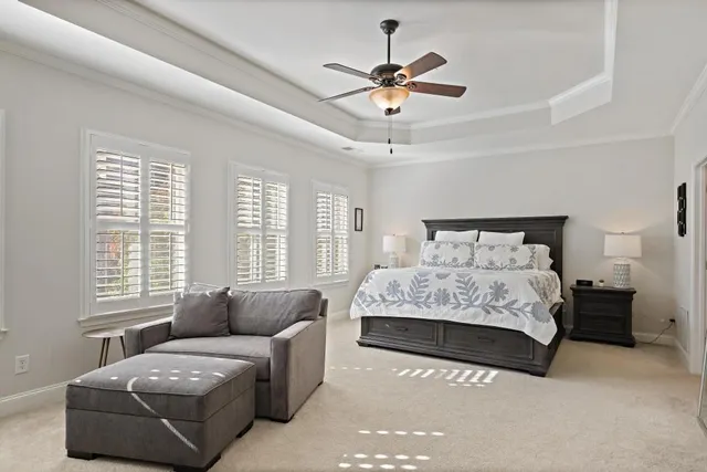 a bedroom with a bed couch and window