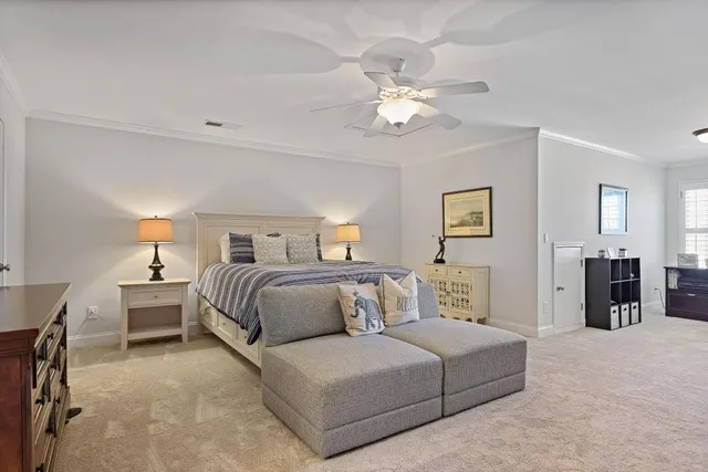 a bedroom with a large bed and a chandelier