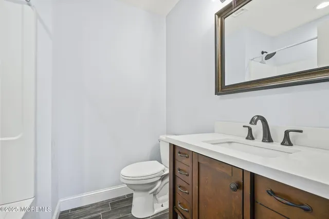an empty room with wooden floor and entrance