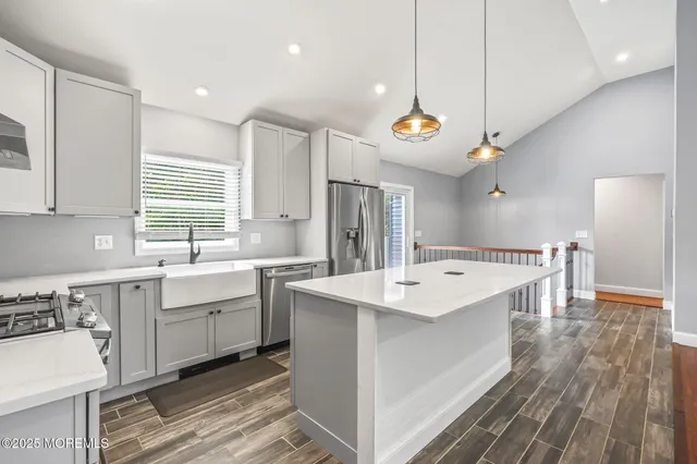 a kitchen with a stove a sink and a refrigerator