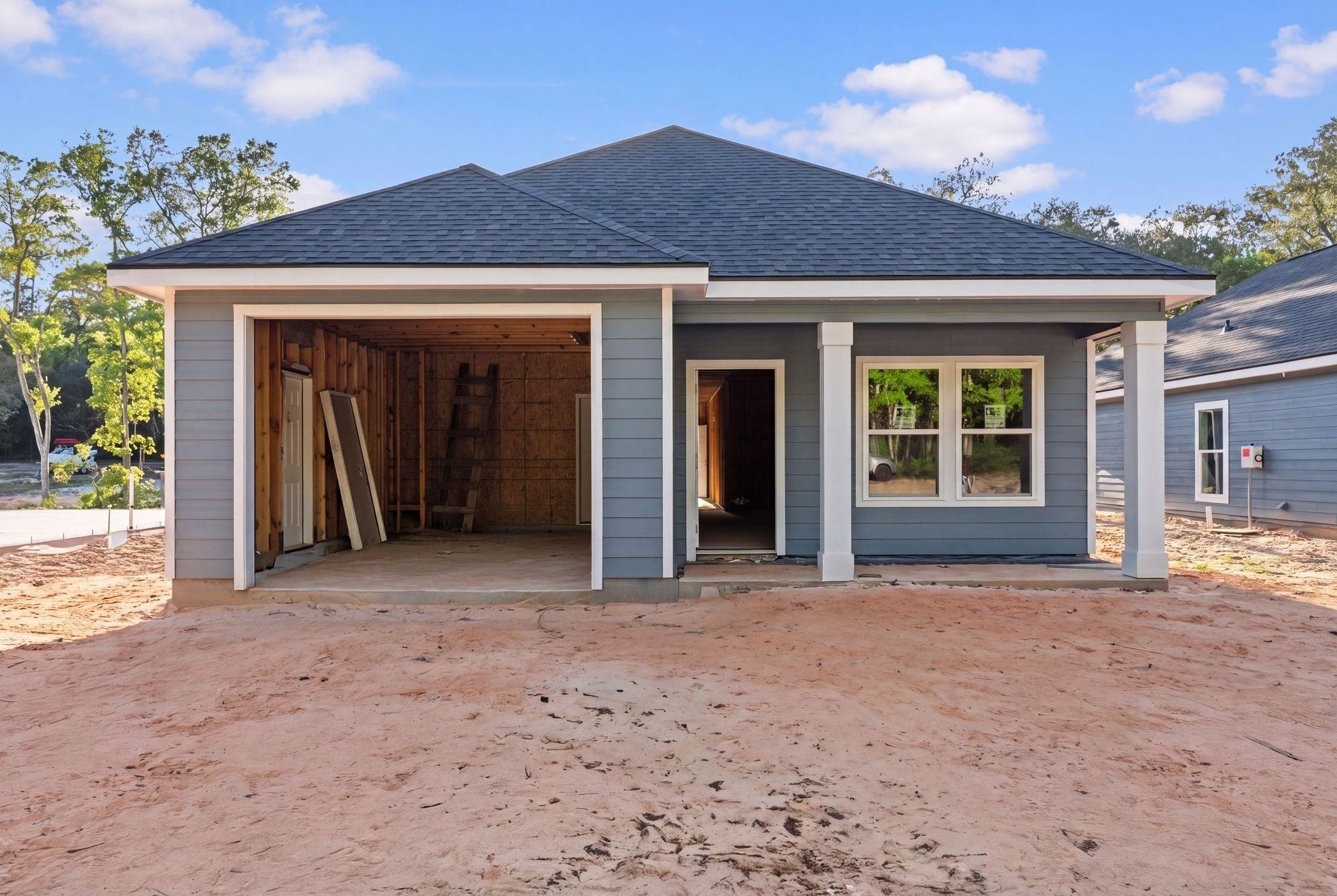 8657 Anniston Drive Elberta, AL 36530 - Photo 1 of 21 View of front of home featuring a shingled roof, a patio, and a garage