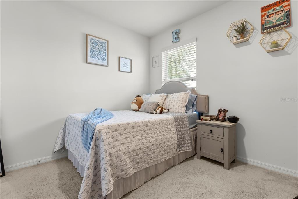 201 Wood Hollow Road DeLand, FL 32724 - Photo 17 of 32 a bedroom with a bed and window