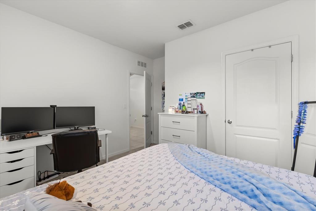 201 Wood Hollow Road DeLand, FL 32724 - Photo 18 of 32 a bedroom with a bed and a flat screen tv