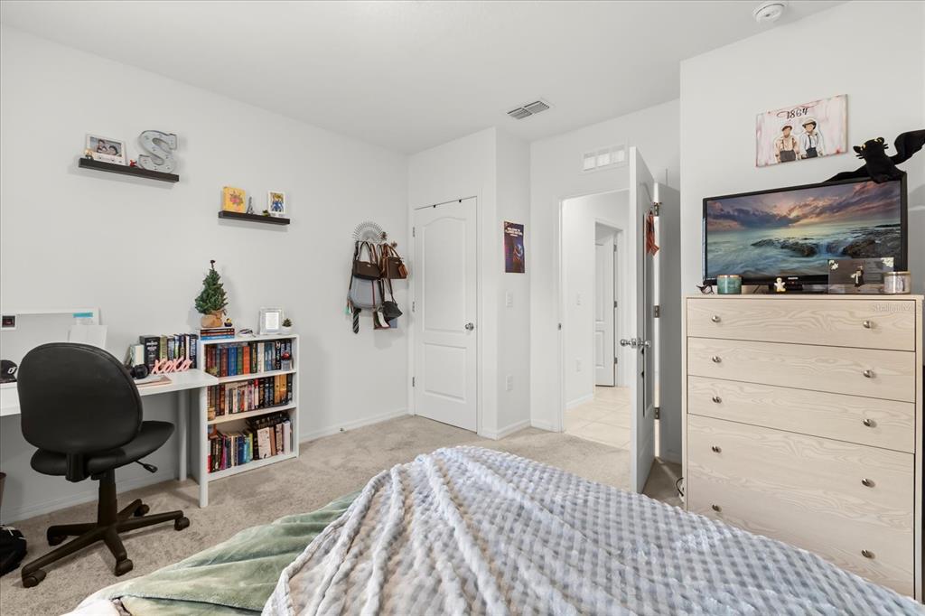 201 Wood Hollow Road DeLand, FL 32724 - Photo 20 of 32 a bedroom with a bed and a chair in it