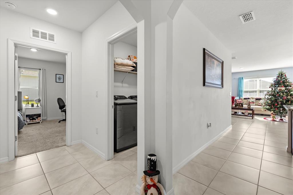 201 Wood Hollow Road DeLand, FL 32724 - Photo 22 of 32 a view of a hallway and a livingroom with furniture