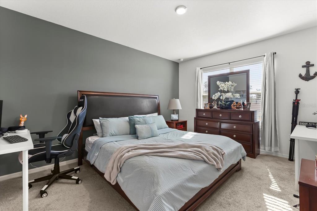 201 Wood Hollow Road DeLand, FL 32724 - Photo 24 of 32 a bedroom with a bed and wooden floor