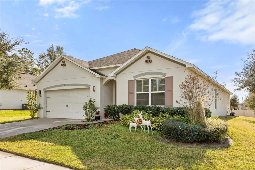 201 Wood Hollow Road DeLand, FL 32724 - Photo 3 of 32 a front view of a house with garden