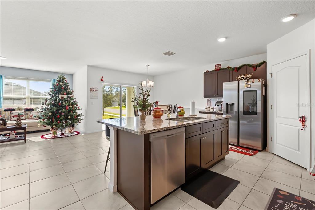 201 Wood Hollow Road DeLand, FL 32724 - Photo 10 of 32 a kitchen with stainless steel appliances granite countertop a refrigerator and a sink