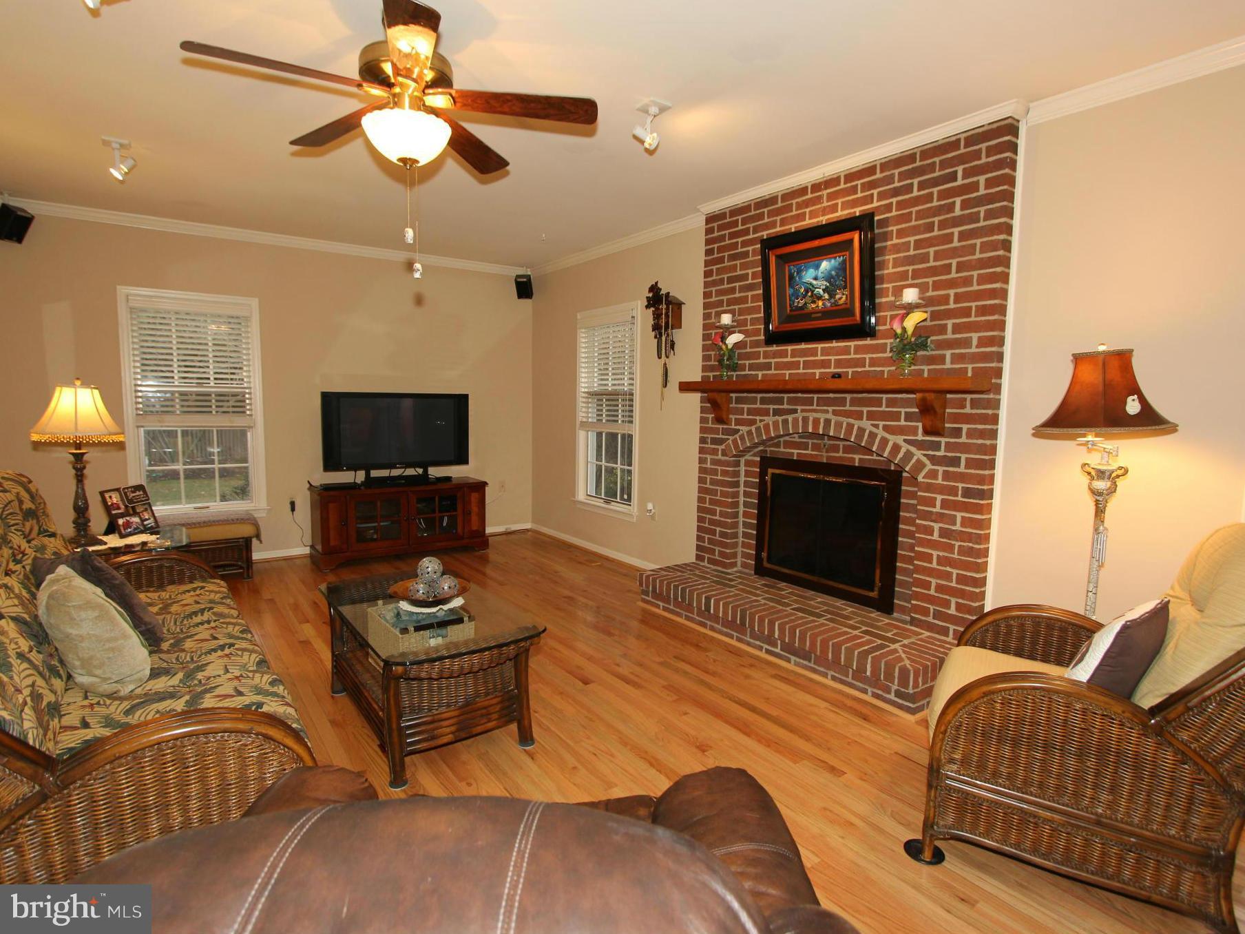 6700 Stone Ridge Court Frederick, MD 21702 - Photo 3 of 30 a living room with furniture a fireplace and a flat screen tv