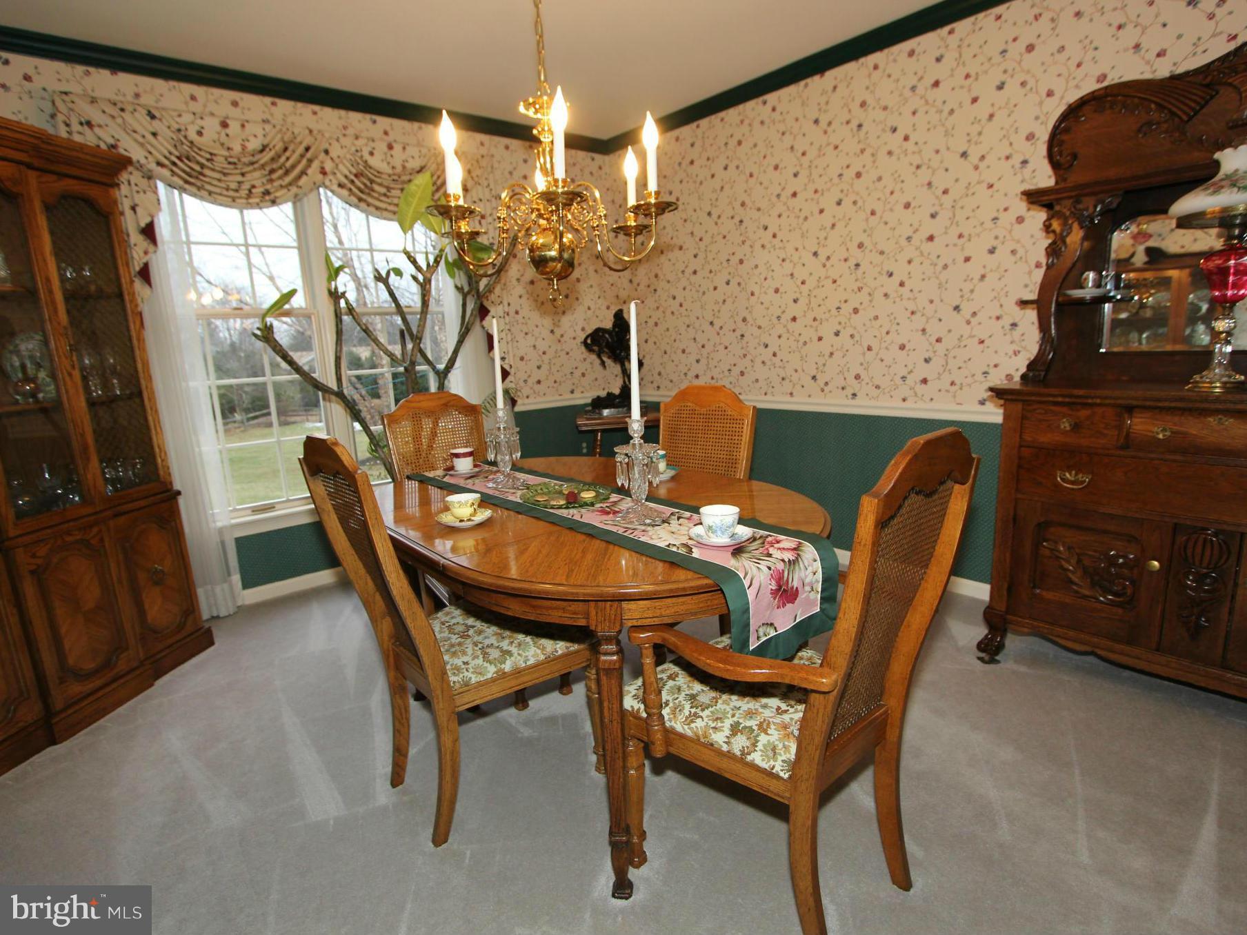 6700 Stone Ridge Court Frederick, MD 21702 - Photo 8 of 30 a view of a dining room with furniture and chandelier