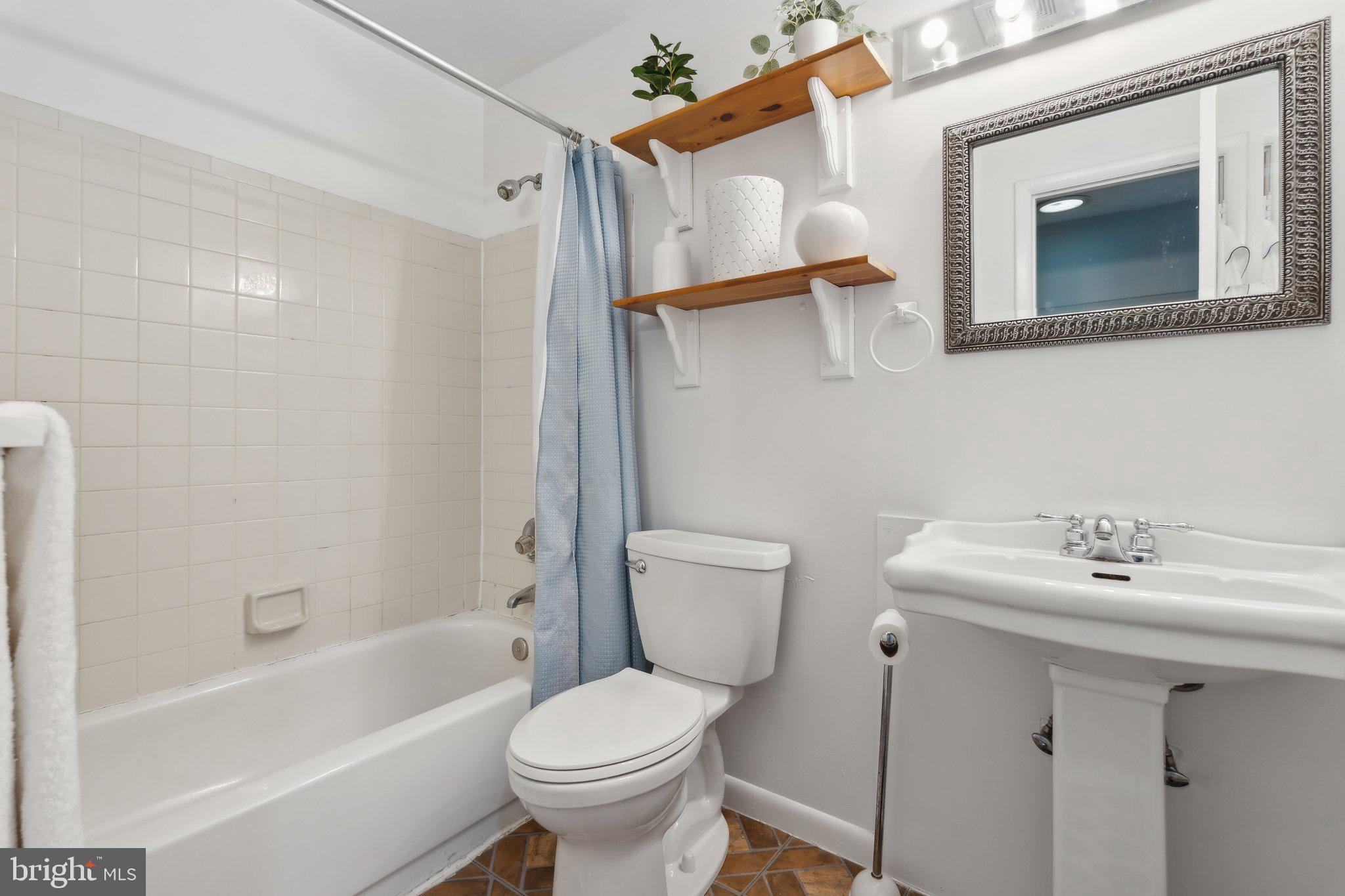 623 Jasper Street Baltimore, MD 21201 - Photo 14 of 32 a bathroom with a sink toilet and shower