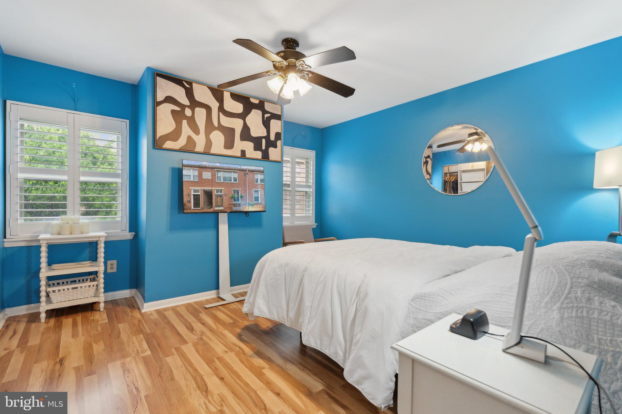 623 Jasper Street Baltimore, MD 21201 - Photo 16 of 32 a bedroom with a bed and a chandelier