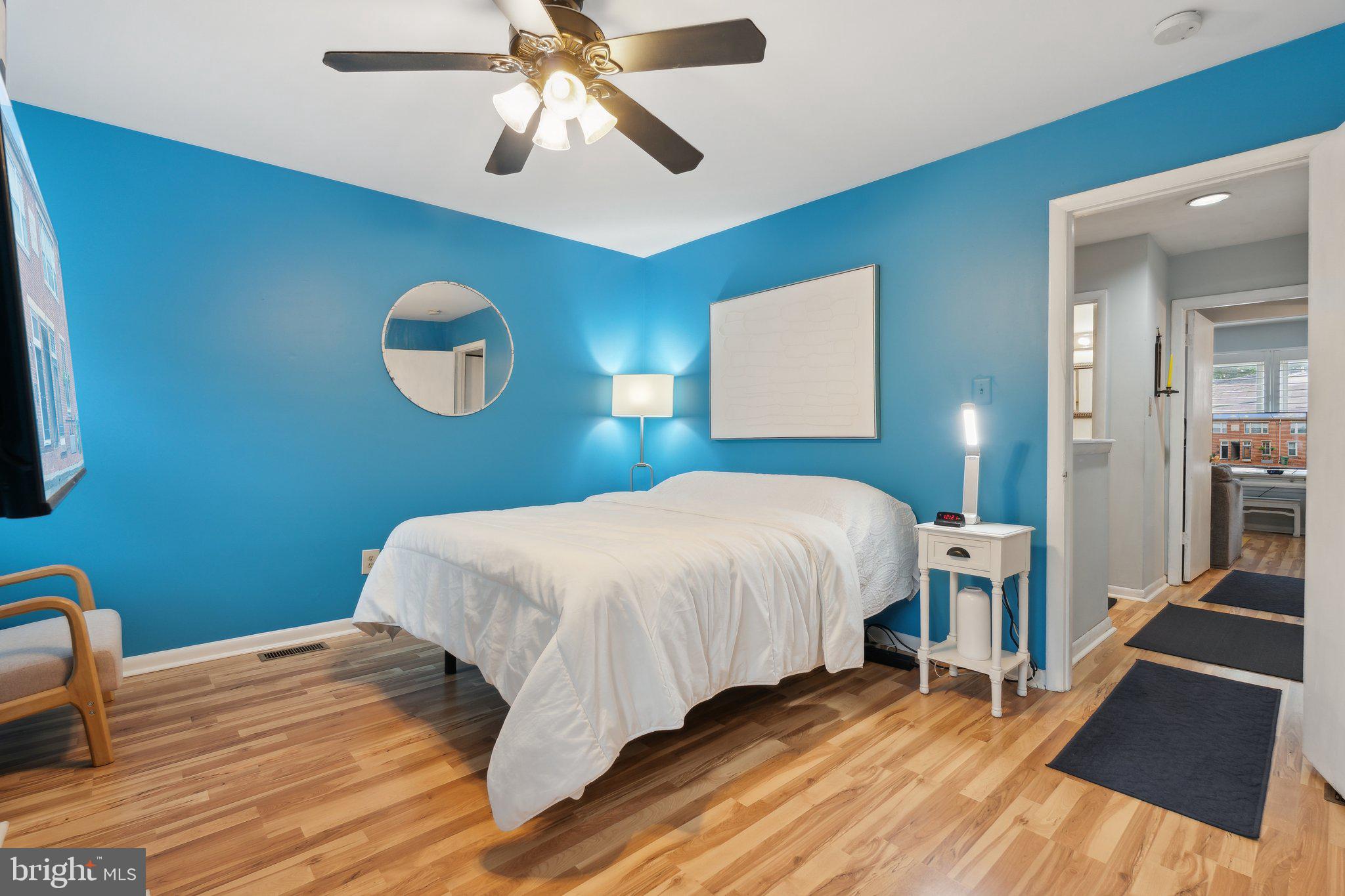 623 Jasper Street Baltimore, MD 21201 - Photo 17 of 32 a bedroom with a bed and wooden floor
