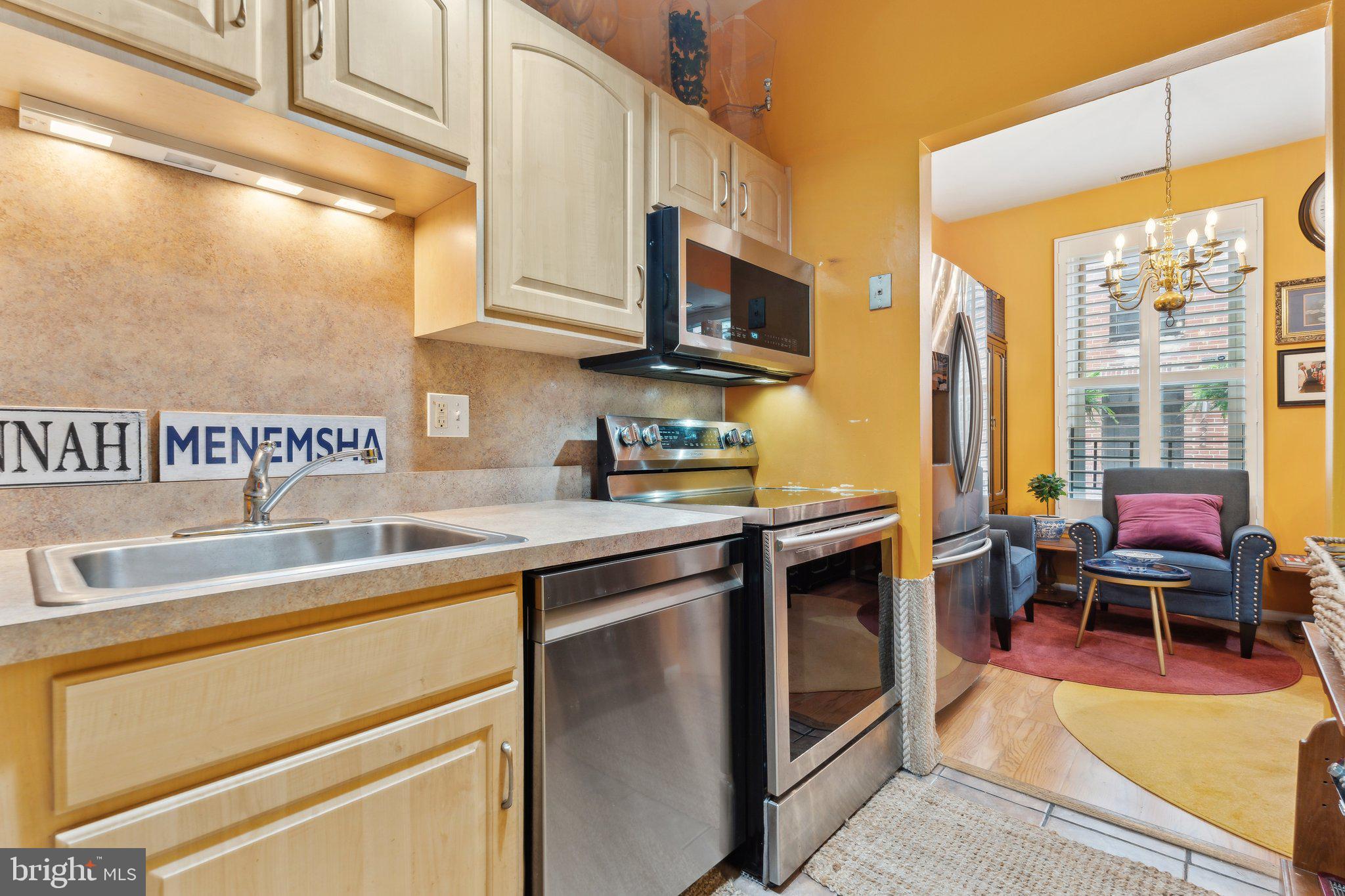 623 Jasper Street Baltimore, MD 21201 - Photo 7 of 32 a kitchen with stainless steel appliances granite countertop a sink and cabinets