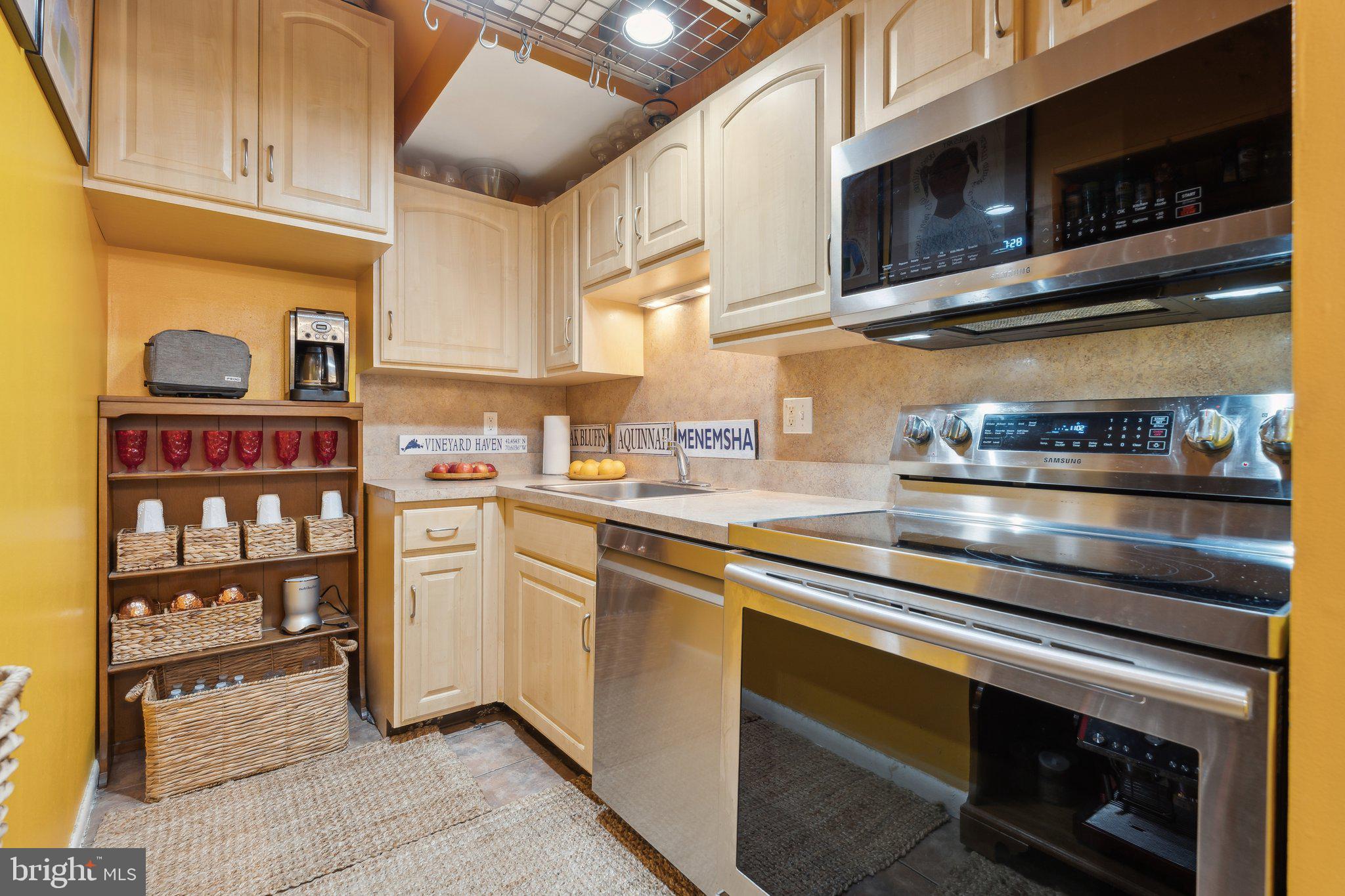 623 Jasper Street Baltimore, MD 21201 - Photo 8 of 32 a kitchen with stainless steel appliances granite countertop a stove microwave and cabinets