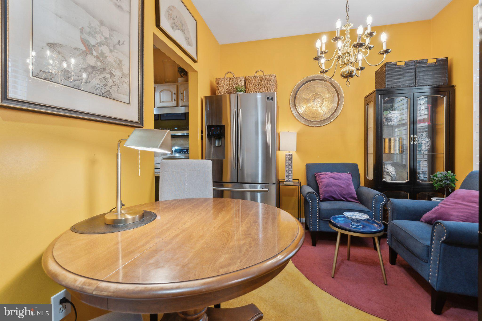 623 Jasper Street Baltimore, MD 21201 - Photo 9 of 32 a living room with couches a clock and a large mirror with potted plants