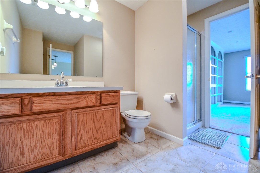 3915 East Summit Ridge Drive Beavercreek, OH 45430 - Photo 37 of 47 This bathroom features a sleek vanity, convenient toilet, and a practical shower area.