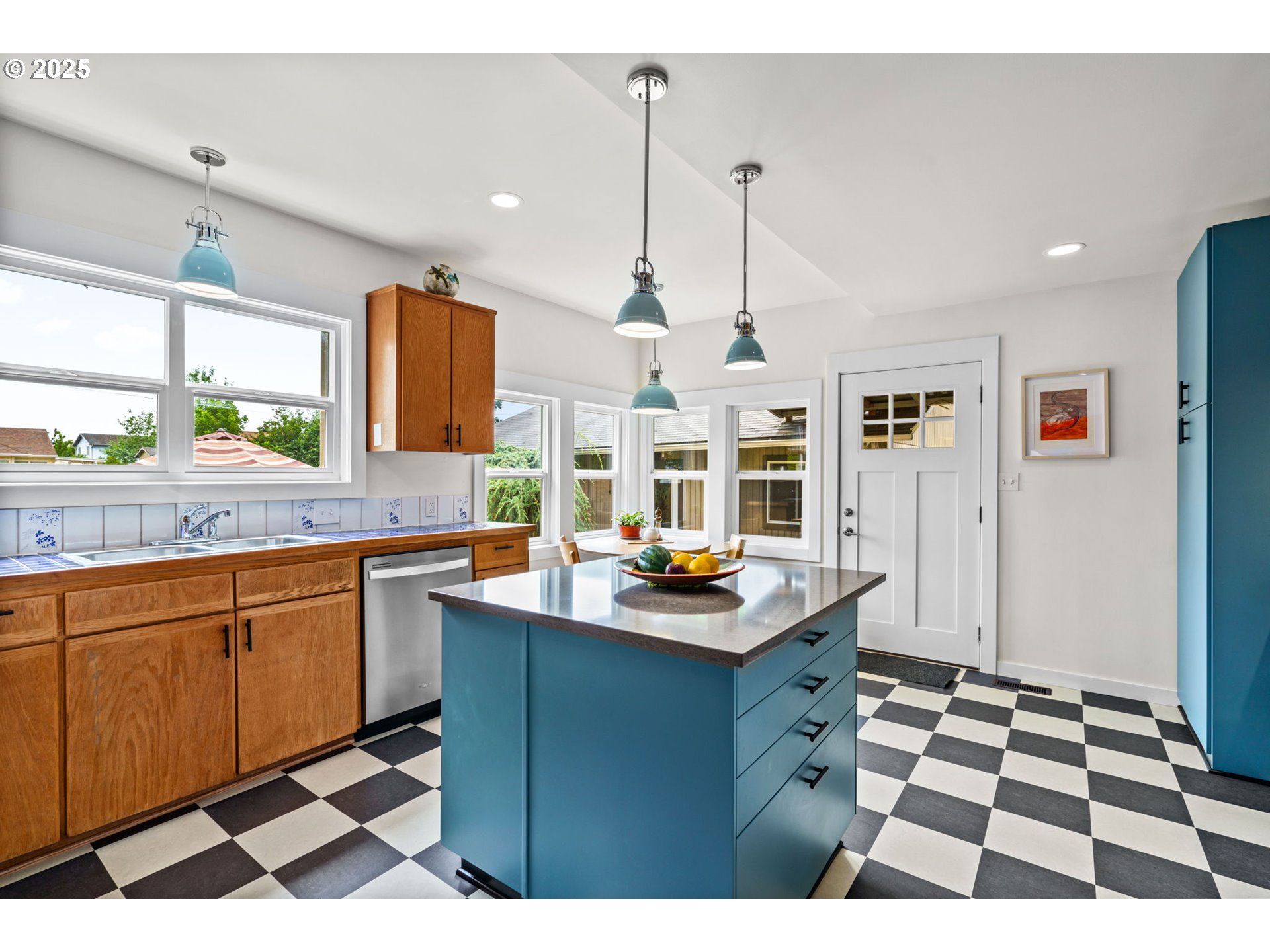 409 North 8th Street Cottage Grove, OR 97424 - Photo 11 of 48 a kitchen with a sink a counter top space and stainless steel appliances