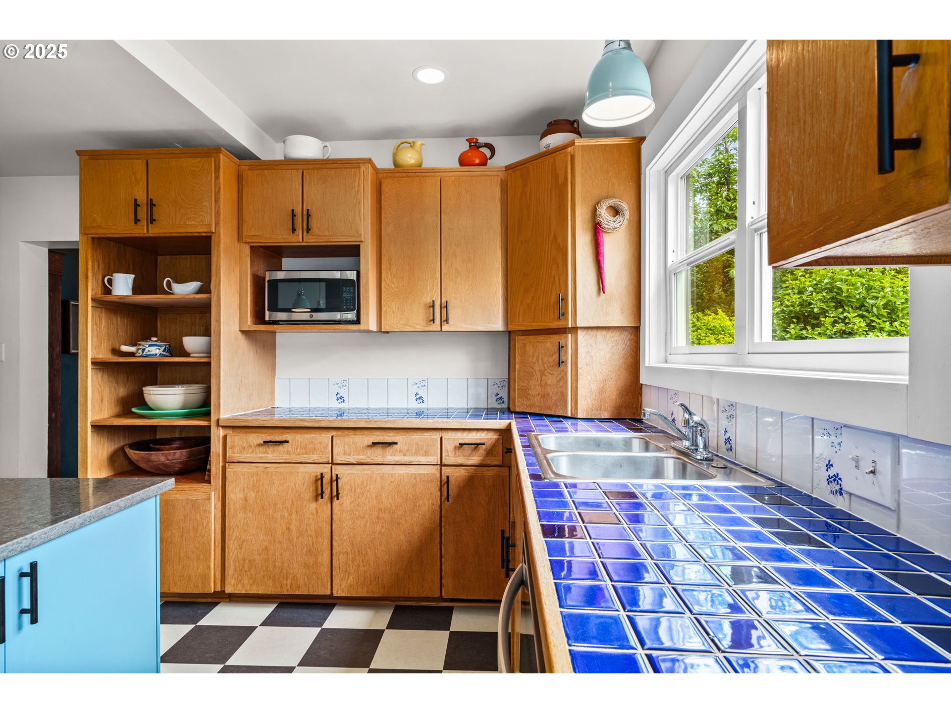 409 North 8th Street Cottage Grove, OR 97424 - Photo 13 of 48 a kitchen with granite countertop a stove a sink and a microwave
