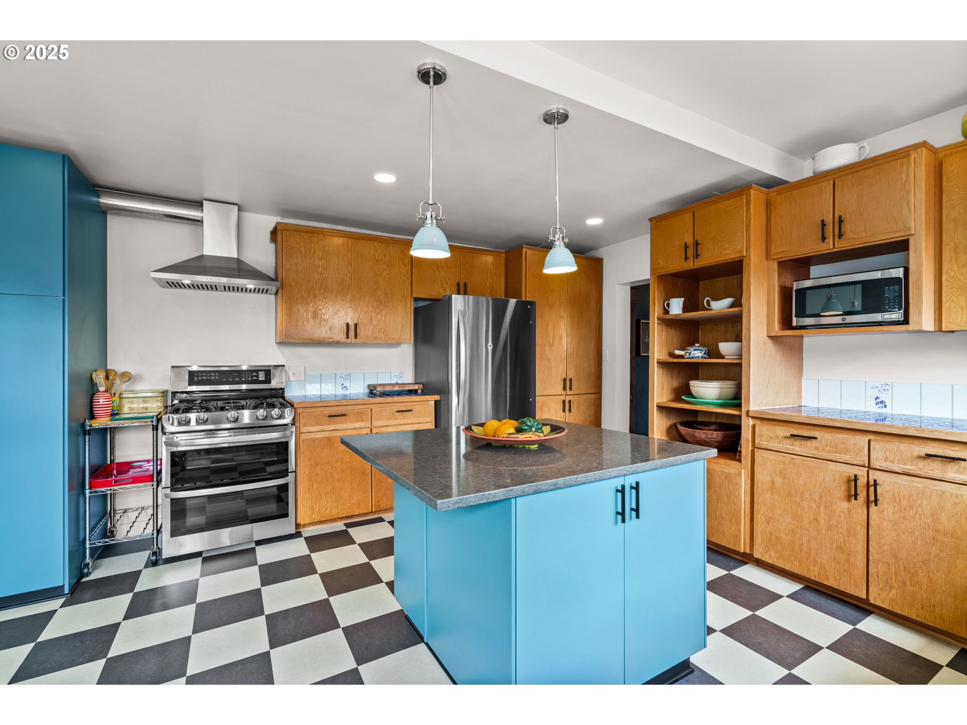 409 North 8th Street Cottage Grove, OR 97424 - Photo 14 of 48 a kitchen with stainless steel appliances kitchen island granite countertop a sink and cabinets