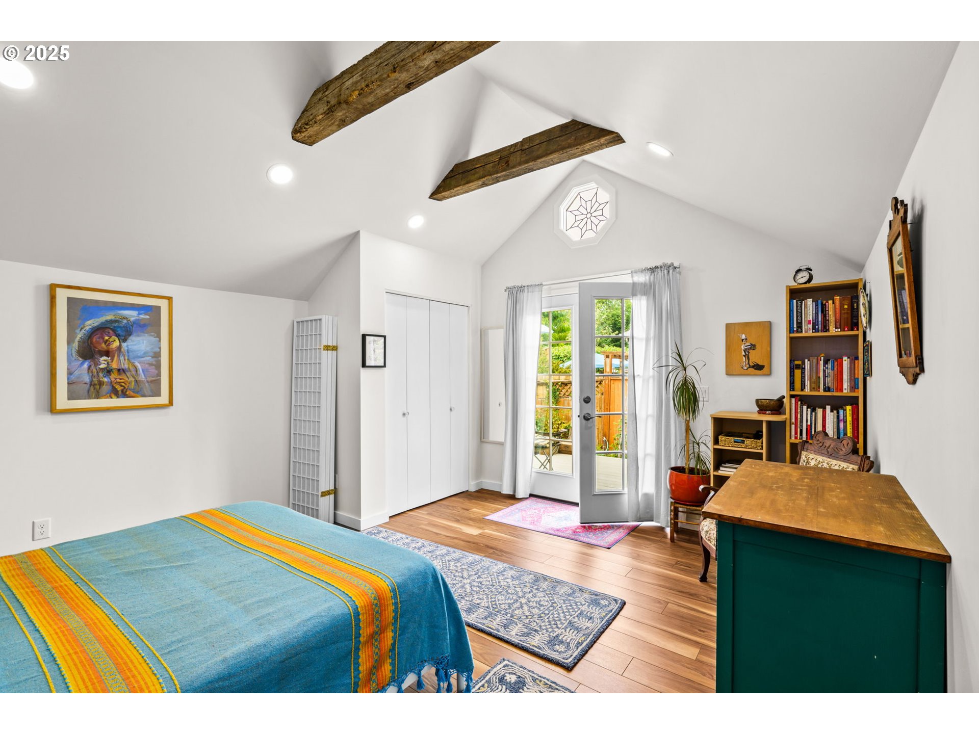 409 North 8th Street Cottage Grove, OR 97424 - Photo 15 of 48 a bedroom with a bed a dresser and a large mirror