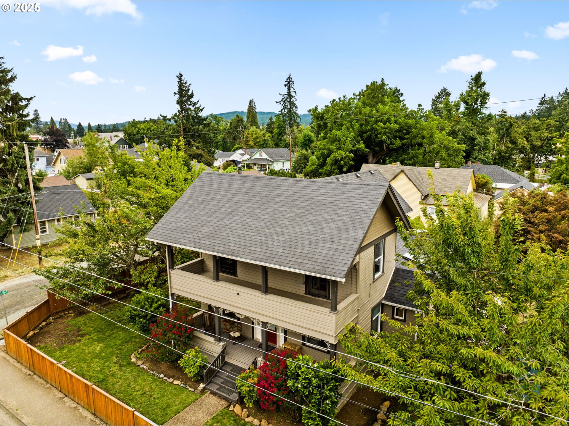 409 North 8th Street Cottage Grove, OR 97424 - Photo 45 of 48 a aerial view of a house with a yard table and chairs