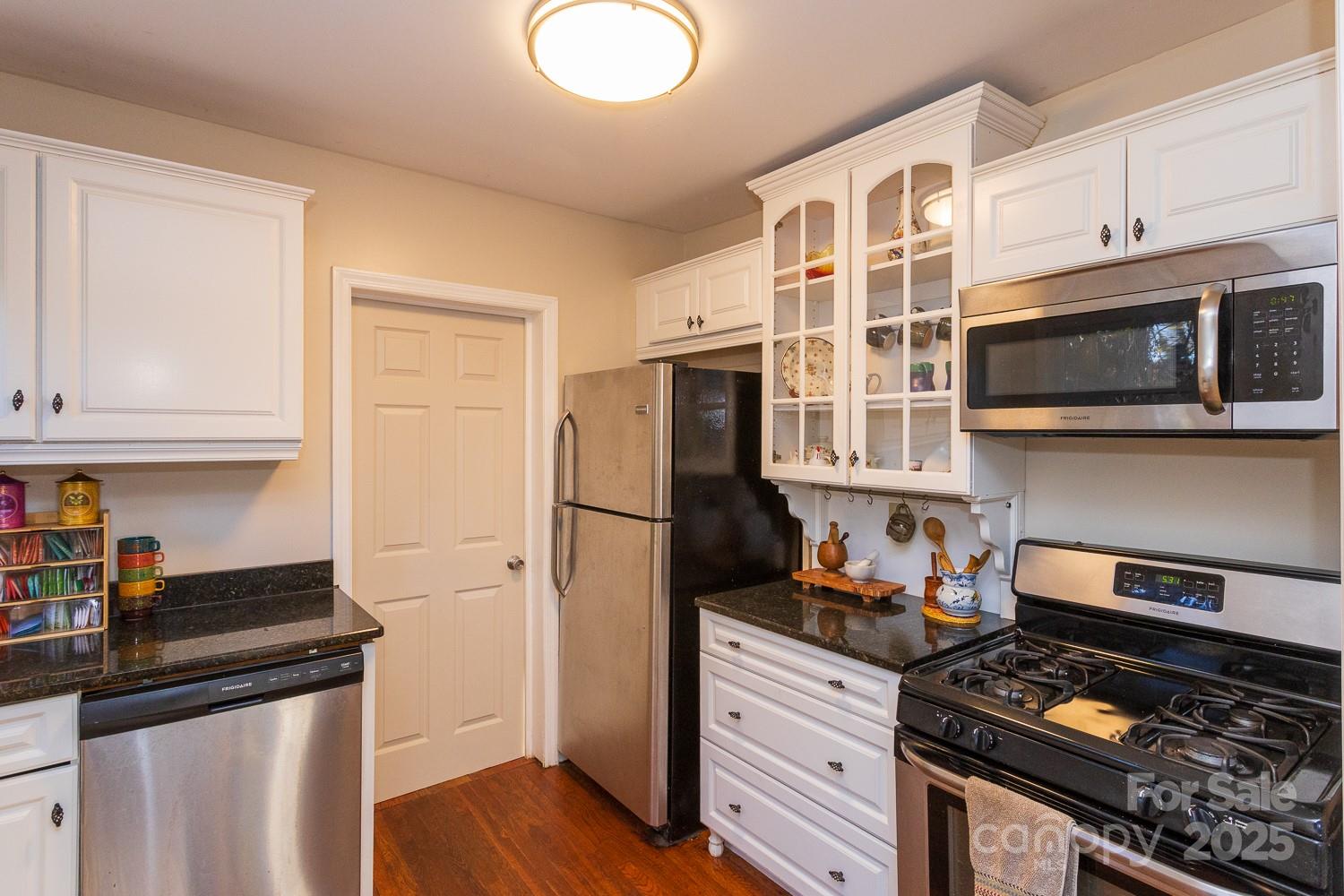 87 Pershing Road Asheville, NC 28805 - Photo 14 of 48 a kitchen with stainless steel appliances granite countertop a stove and a refrigerator