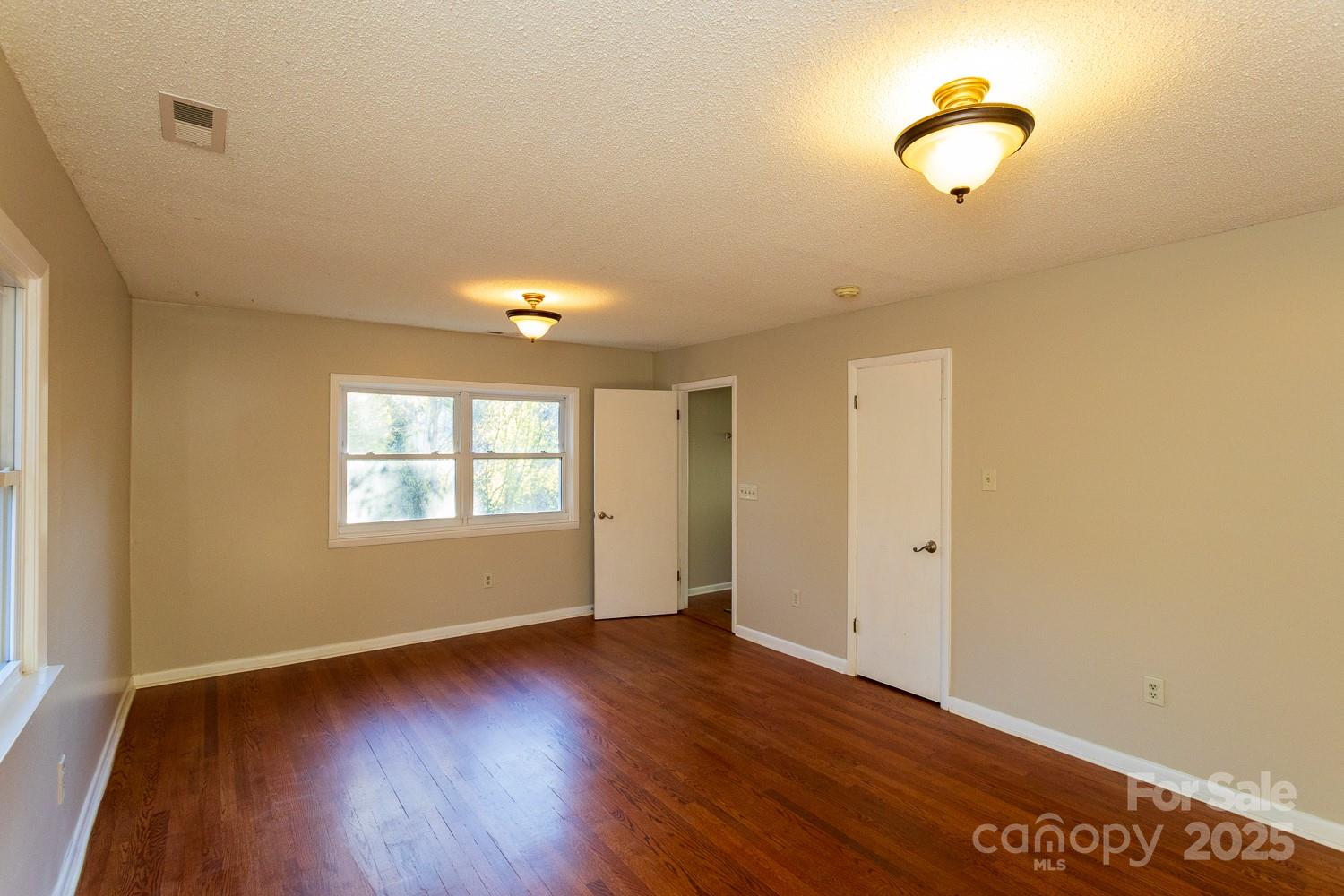 87 Pershing Road Asheville, NC 28805 - Photo 15 of 48 a view of room with window and wooden floor