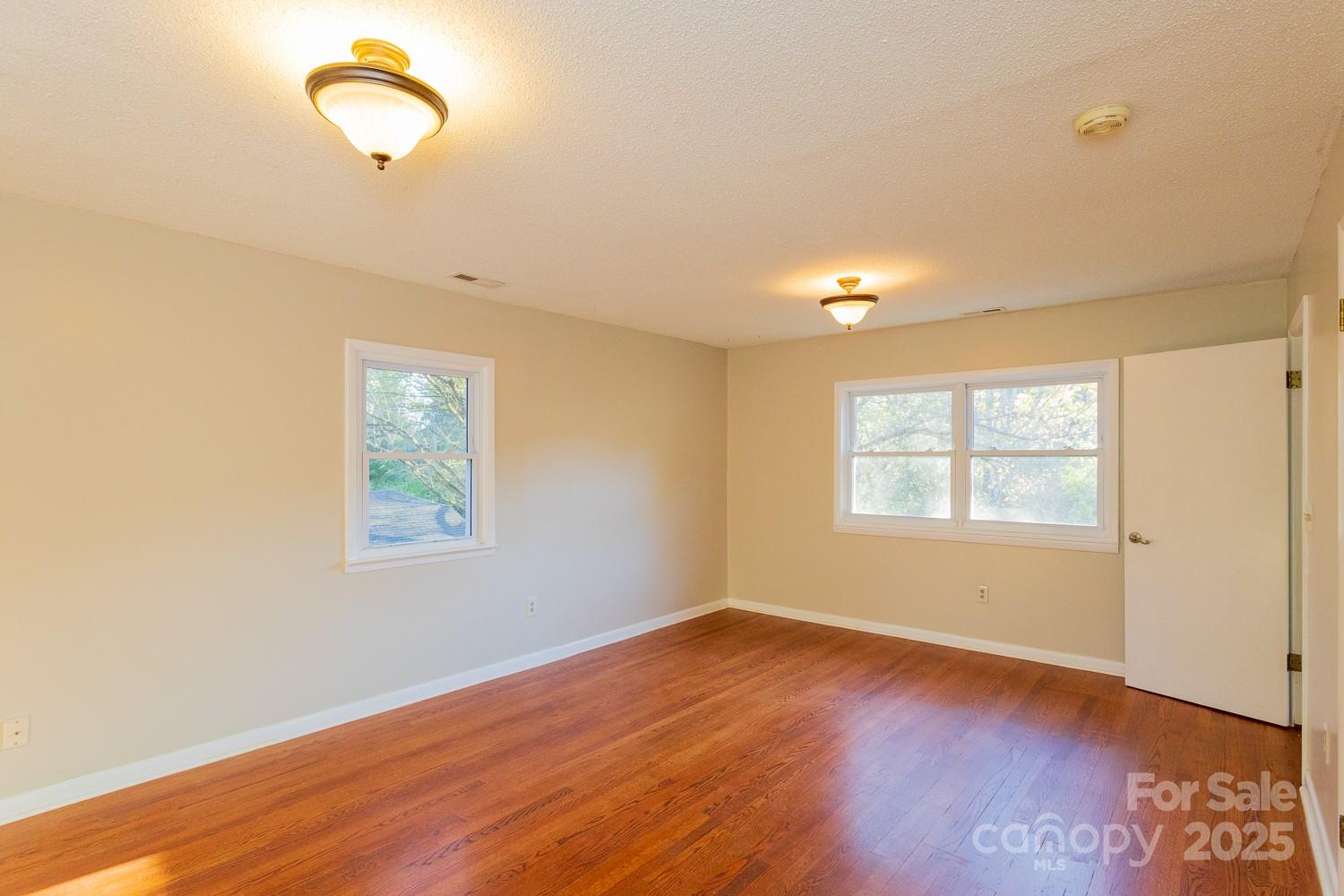 87 Pershing Road Asheville, NC 28805 - Photo 16 of 48 a view of empty room with wooden floor and fan