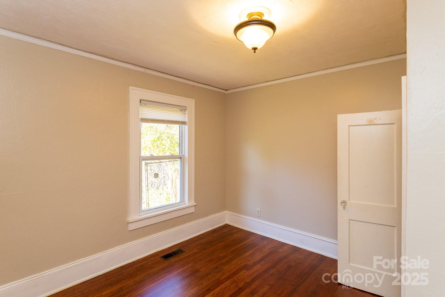 87 Pershing Road Asheville, NC 28805 - Photo 19 of 48 a view of a room with wooden floor and windows