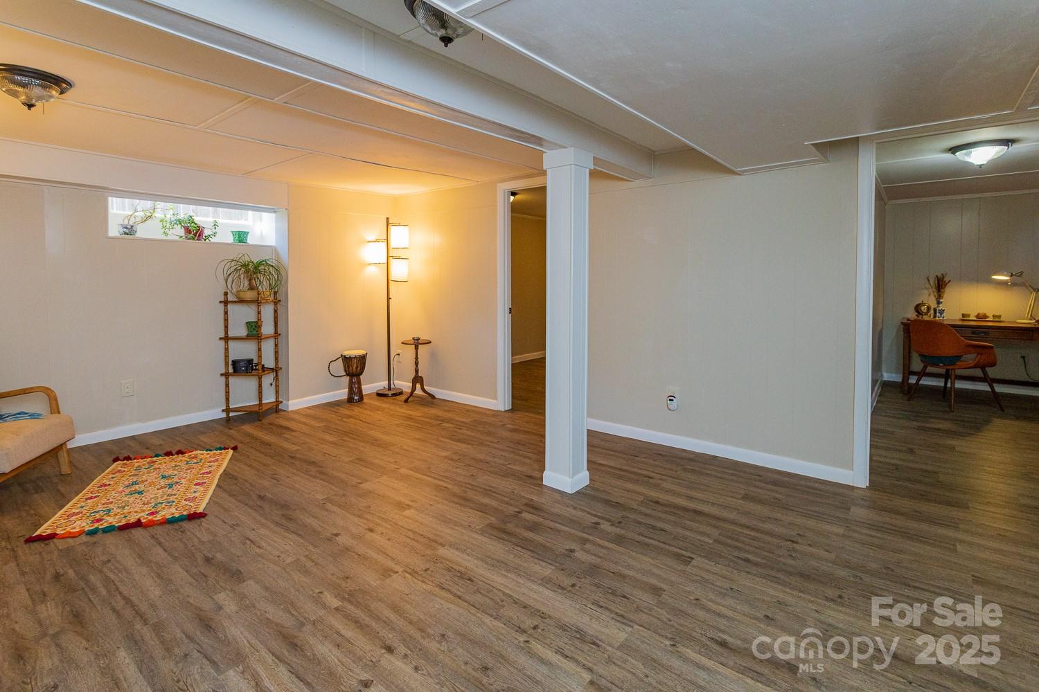 87 Pershing Road Asheville, NC 28805 - Photo 26 of 48 a view of a livingroom with wooden floor and lounge chair