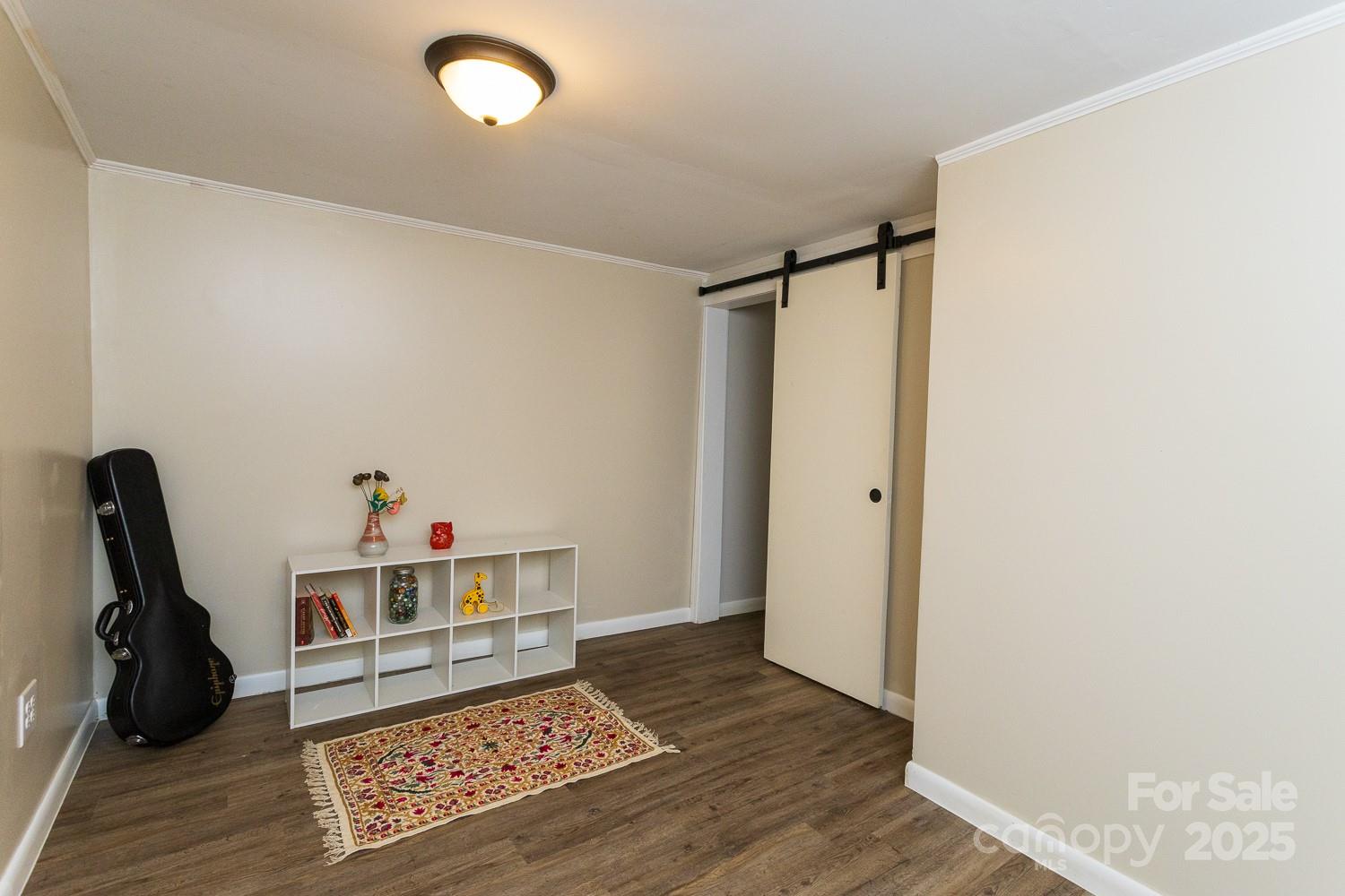 87 Pershing Road Asheville, NC 28805 - Photo 27 of 48 a living room with hard wood floors and a fireplace