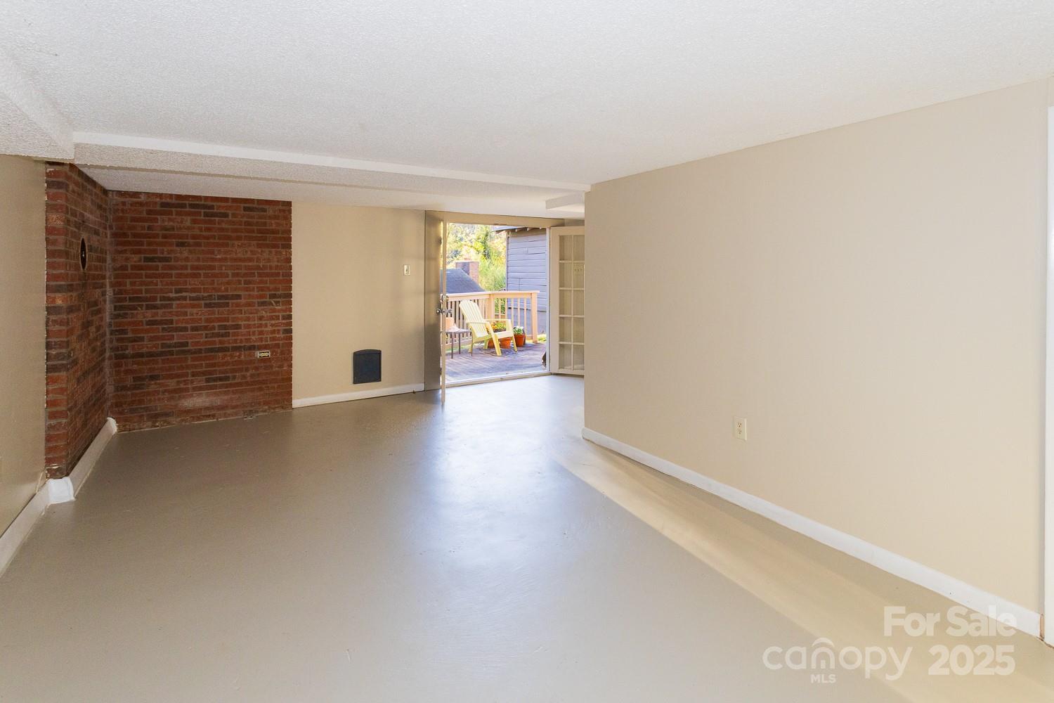 87 Pershing Road Asheville, NC 28805 - Photo 30 of 48 a view of an empty room with a window