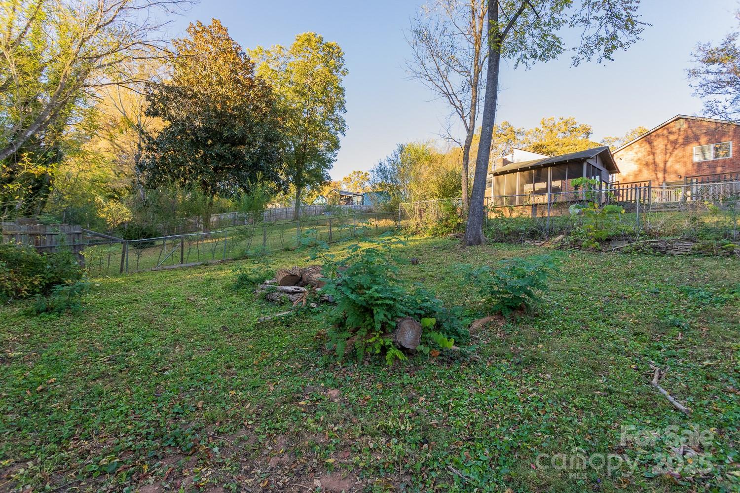 87 Pershing Road Asheville, NC 28805 - Photo 34 of 48 a backyard of a house with lots of green space