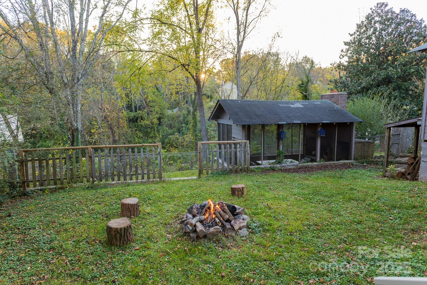 87 Pershing Road Asheville, NC 28805 - Photo 38 of 48 a front view of a house with garden and trees