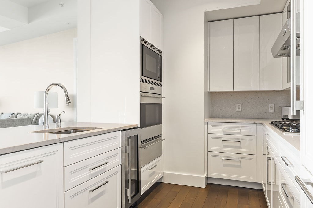 22 Liberty Drive, Unit 2F Boston, MA 02210 - Photo 11 of 28 a kitchen with cabinets appliances a sink and a window