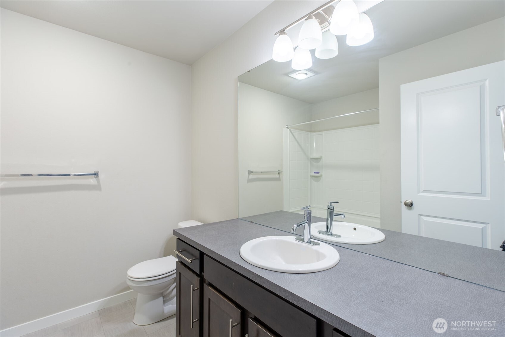 15113 40th Avenue West, Unit B2 Lynnwood, WA 98087 - Photo 14 of 36 a bathroom with a granite countertop sink a toilet and a mirror