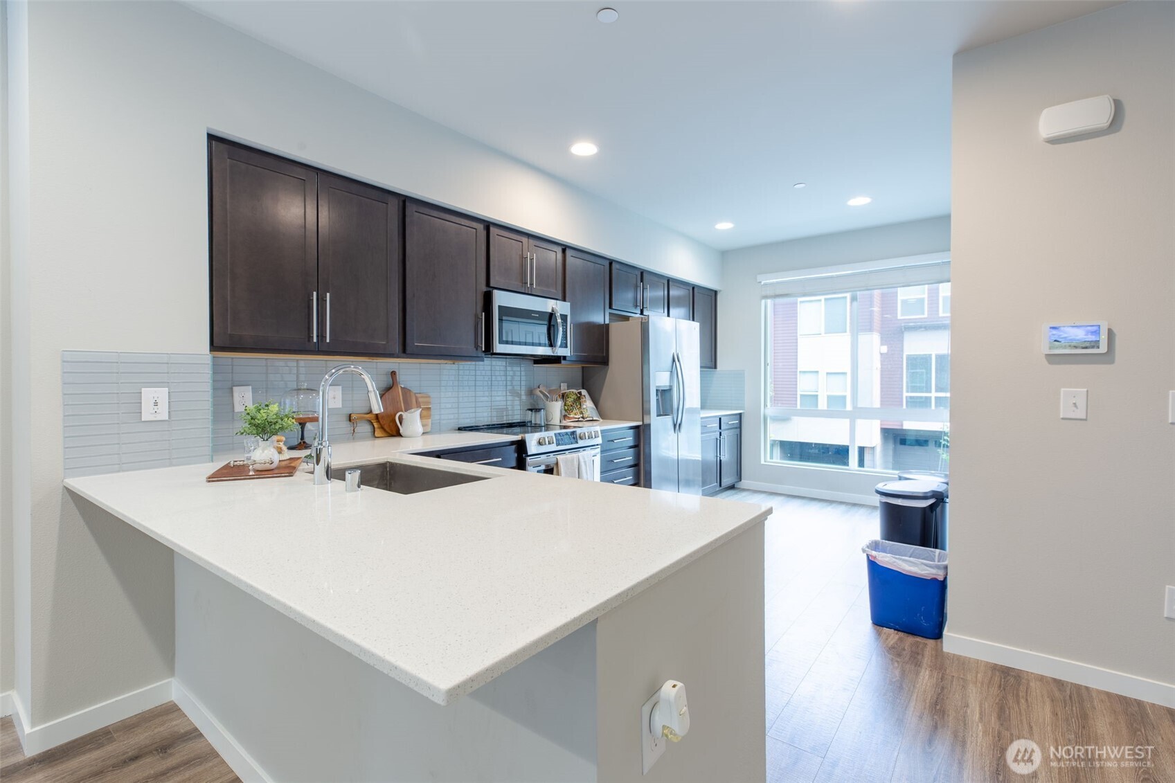 15113 40th Avenue West, Unit B2 Lynnwood, WA 98087 - Photo 29 of 36 a kitchen with a sink a refrigerator and wooden floor