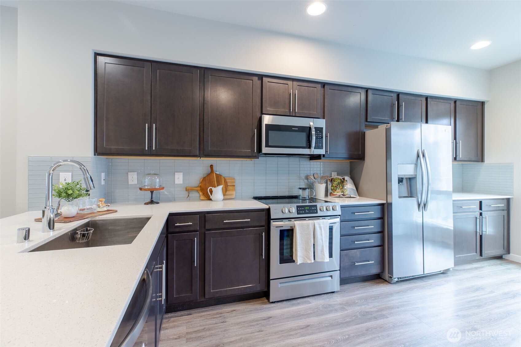 15113 40th Avenue West, Unit B2 Lynnwood, WA 98087 - Photo 30 of 36 a kitchen with kitchen island granite countertop stainless steel appliances and wooden cabinets