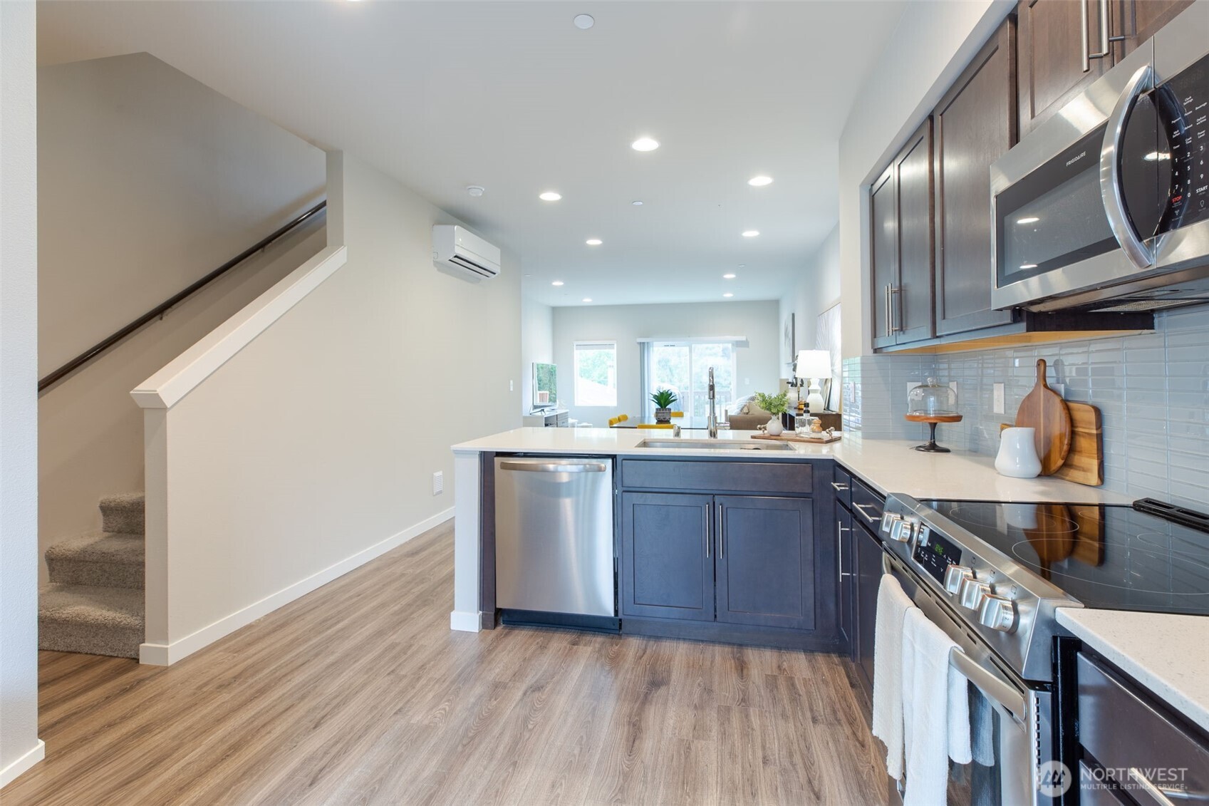 15113 40th Avenue West, Unit B2 Lynnwood, WA 98087 - Photo 33 of 36 a kitchen with stainless steel appliances granite countertop a sink a stove and a wooden floors
