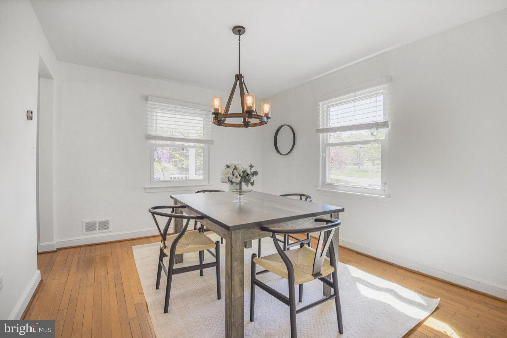 10002 Reddick Drive Silver Spring, MD 20901 - Photo 11 of 33 a view of a dining room and livingroom with furniture window wooden floor