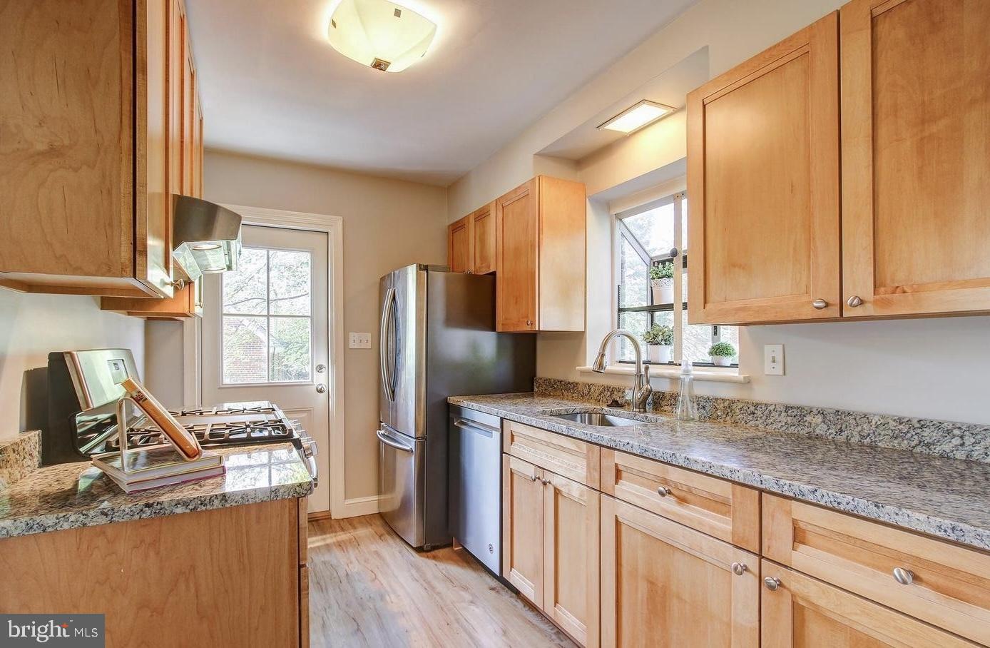 10002 Reddick Drive Silver Spring, MD 20901 - Photo 13 of 33 a kitchen with refrigerator cabinets and a sink